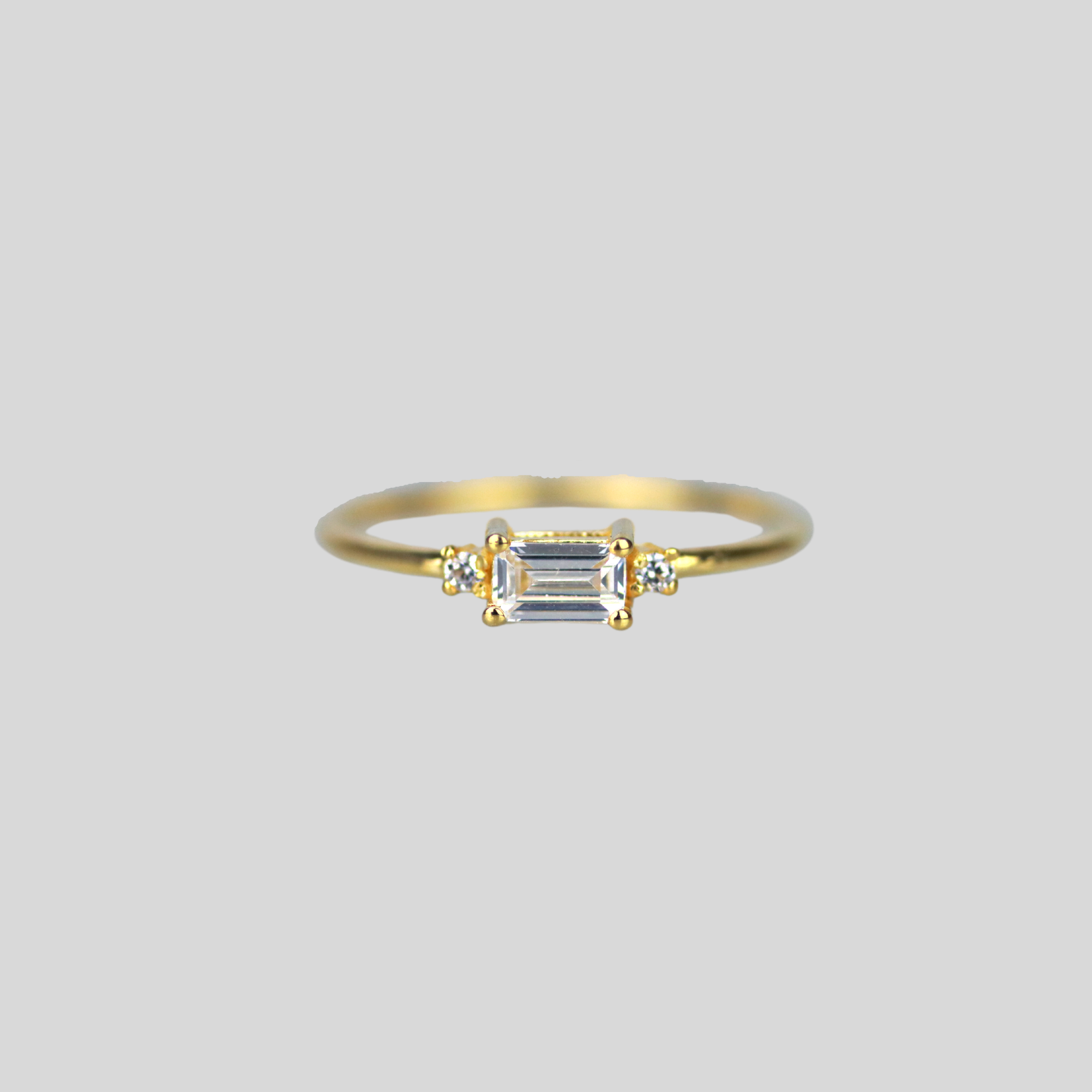 Solid 14k gold ring with east-west emerald cut cz